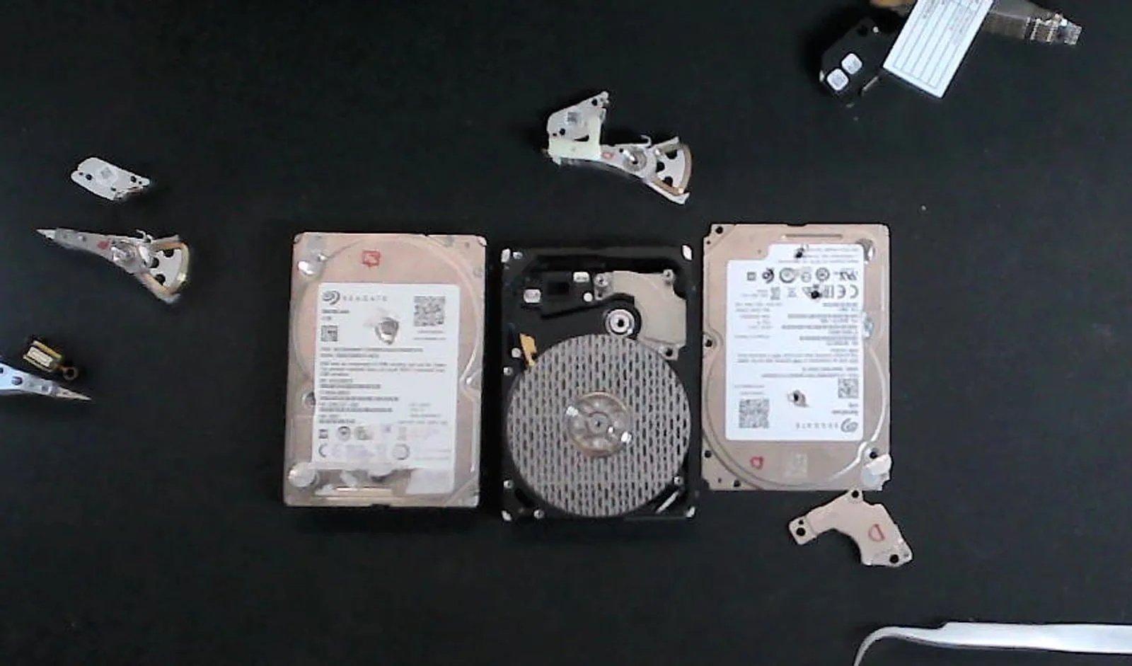 Failed hard drive positioned with compatible donor drives and donor head assemblies