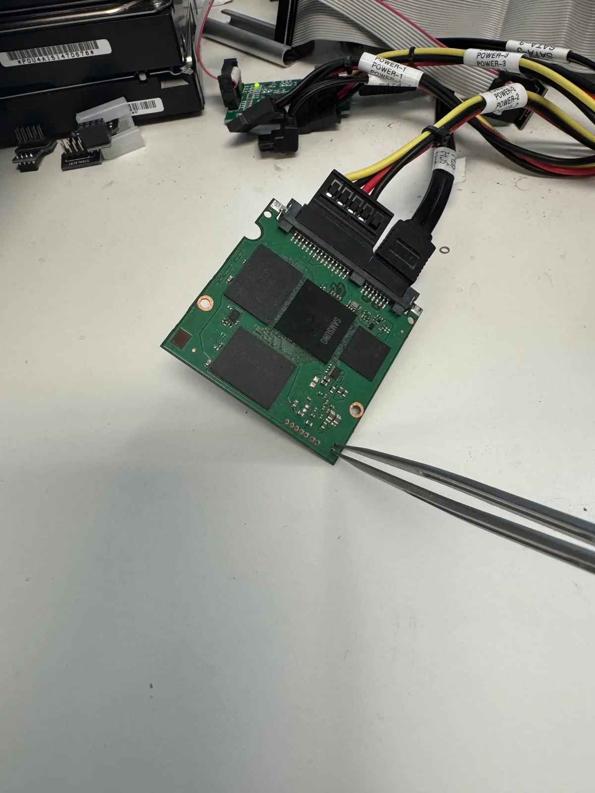 Samsung SSD circuit board connected to professional recovery equipment